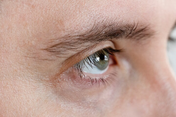 Obraz premium Macro Studio Expression Shot Of man's green Eye With Close Up On Eyelashes And Pupil