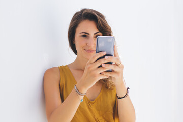 Woman taking selfie on smartphone and smiling