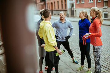 Young people stretching and getting ready to go jogging in the city