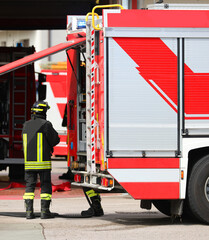 fire truck with a firefighter in uniform wearing a protective helmet during an emergency