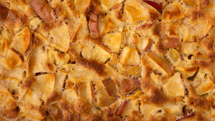 freshly baked apple charlotte completely fills the frame. top view. background photo in 16x9 format