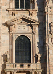 facade of the cathedral with latin inscription meaning mary being born located in milan in italy