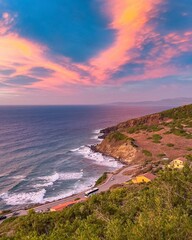 Beautiful ocean coast sunset with big waves.