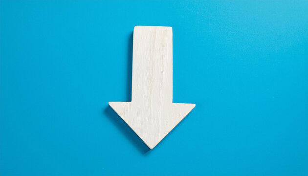 White wooden arrow pointing down on blue background. Business, market decline or economic.