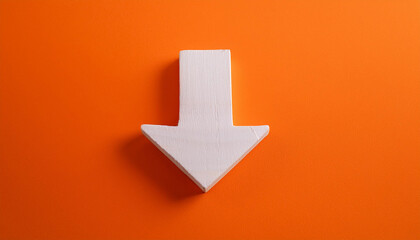 White wooden arrow pointing down on orange background. Business, market decline or economic.