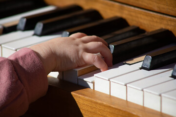 Baby playing a piano at the pumpkin patch piano on a beautiful October day