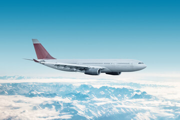 Obraz premium Wide body passenger airplane flying in the air over mountains