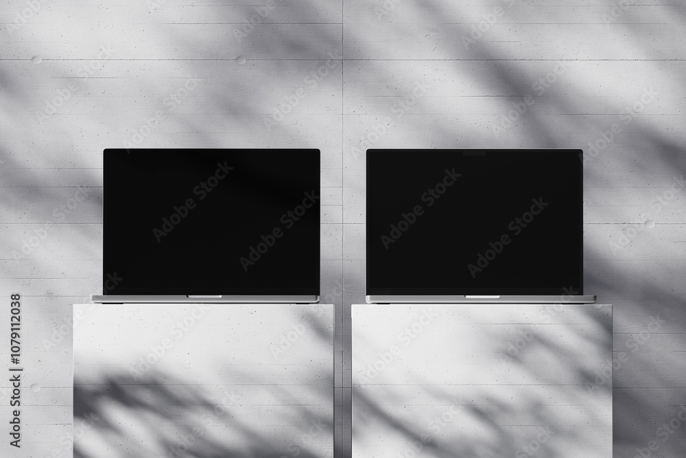 Wall mural scene with an open laptop with a blank screen on a concrete background