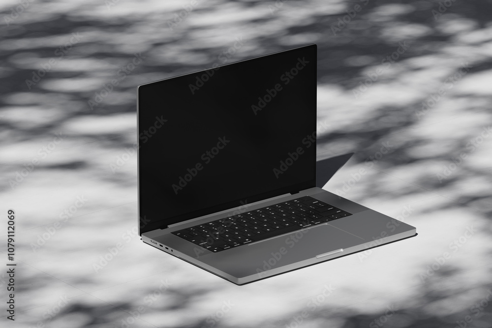 Wall mural scene with an open laptop with a blank screen on a concrete background