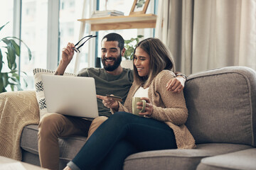 Laptop, coffee and couple on sofa in apartment planning cost, finance and budget for vacation. Happy, computer and people in living room booking accommodation online for travel, holiday or trip.