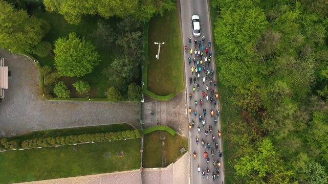 Bicycle race on the highway. A group of cyclists are riding along the road, competing with each other in bicycle races. Bicycle race among professional athletes