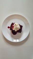 brownie with raspberry glaze and whipped cream