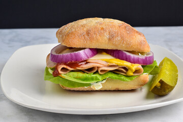 turkey sandwich  with lettuce , onions and swiss cheese