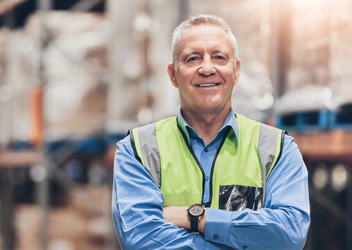 Logistics, mature man and portrait with arms crossed in warehouse for supply chain or distribution manager. Shipping industry, worker and happy for quality assurance duty or cargo supplier in factory