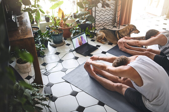 Men, fitness and stretching with laptop screen for online class, streaming or yoga tutorial on floor at home. Male people, friends and pilates with computer for healthy guide, tips or exercise on mat