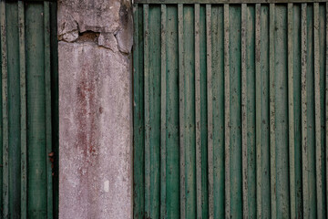 Weathered aged wooden fence with rustic vertical slats