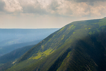 Stunning Mountain Landscape with Lush Green Hills Under Cloudy Sky