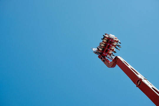 Newcastle UK: 26th June 2024: Newcastle Hoppings funfair. Apollo 13 Thrilling amusement park ride soaring against a clear blue sky