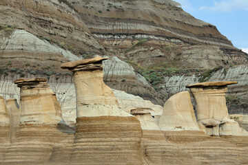 Sandstone hoodoos created by erosion in scenic badlands in summer. © Saeedatun