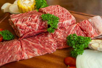 raw meat with vegetables on the wooden board