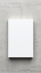 Hardcover book mockup on textured concrete wall background with copy space, design template for book cover presentation or branding showcase, texture, top view