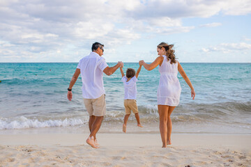 Happy family on the tropical beach. Family vacation