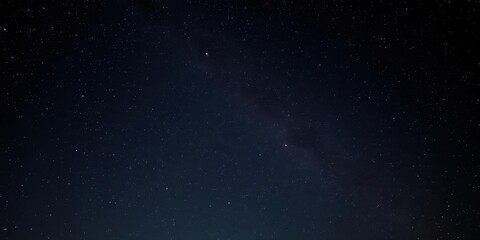 Fototapeta premium Night sky with twinkling stars in a pitch black background, astronomy, astral