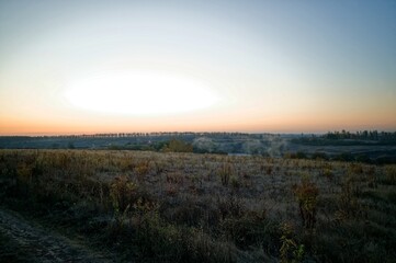 Dirt road through a field in the early morning