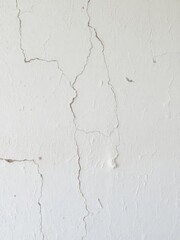 Naklejka premium Rough texture of aged white wall with cracks and imperfections, plaster, texture
