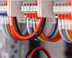 Connection of electrical modules using insulated copper electrical wires. Close-up. Soft focus.