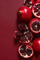 A fresh juicy pomegranate on a red background.