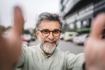 Fototapeta premium self portrait of senior mature man smile and pose outdoor