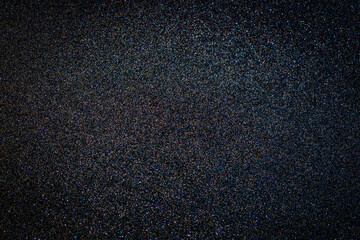 Metallic glitter grainy black wrapping paper background.