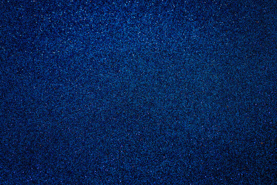 Metallic glitter grainy blue wrapping paper background.
