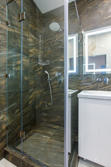 Modern furnished bathroom dark grey interior design with granite tiles