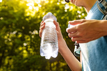 person drinking water from bottle