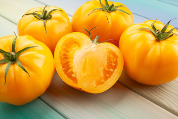 sliced yellow tomato on wood background