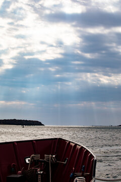 Sun gliding through clouds at cape cod Canal 