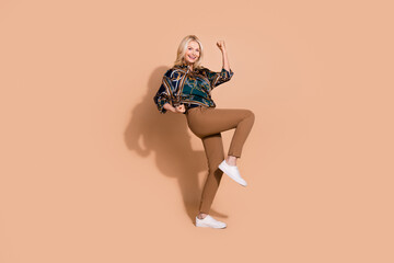 Obraz premium Photo portrait of blonde hair happy mature successful business lady celebrating awesome triumph isolated on beige color background