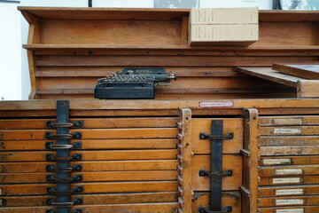 old typewriter on a typeface storage chest. typography letters