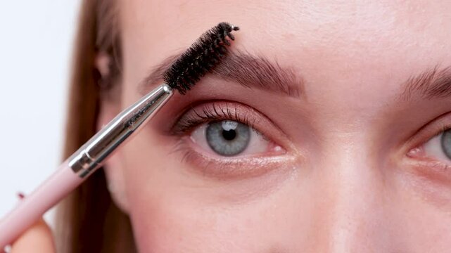 The make-up artist does Long-lasting styling of the eyebrows and will color the eyebrows. Eyebrow lamination. Professional make-up and face care.