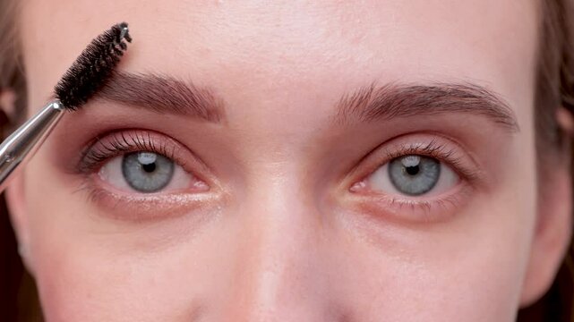 The make-up artist does Long-lasting styling of the eyebrows and will color the eyebrows. Eyebrow lamination. Professional make-up and face care.