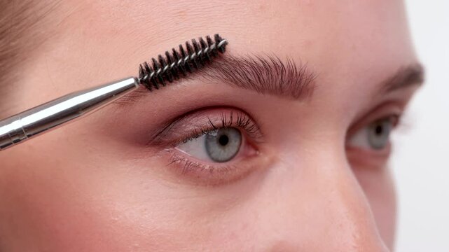 The make-up artist does Long-lasting styling of the eyebrows and will color the eyebrows. Eyebrow lamination. Professional make-up and face care.