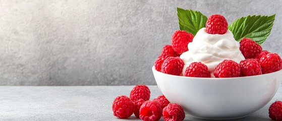 A bowl of whipped cream and raspberries on a table