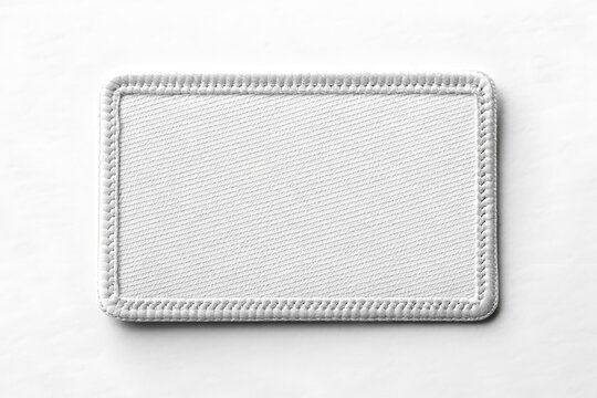 Blank rectangular fabric patch mockup with stitched border on white background, perfect for branding design.