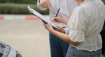 Car Accident Insurance Claim: A closeup of a car accident scene where a man is pointing at a...