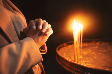 a woman hand lit a candle in the church. Armenia
