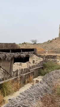 The Hatta Watchtower stands prominently atop the mountain ridge, overlooking the inland enclave of Hatta Heritage Village in Dubai.