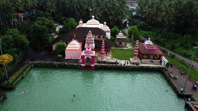 view of the Hindu temple of Shree Rameshwar Mandir, Chaul surrounded by greenery in Revdanda, India