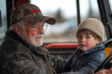Fototapeta premium Grandfather and grandson joyfully driving a tractor on the family farm
